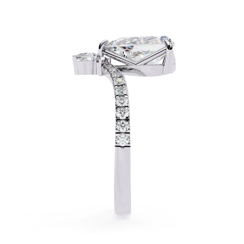 Diamond ring with a pear-shaped center stone on a white background
