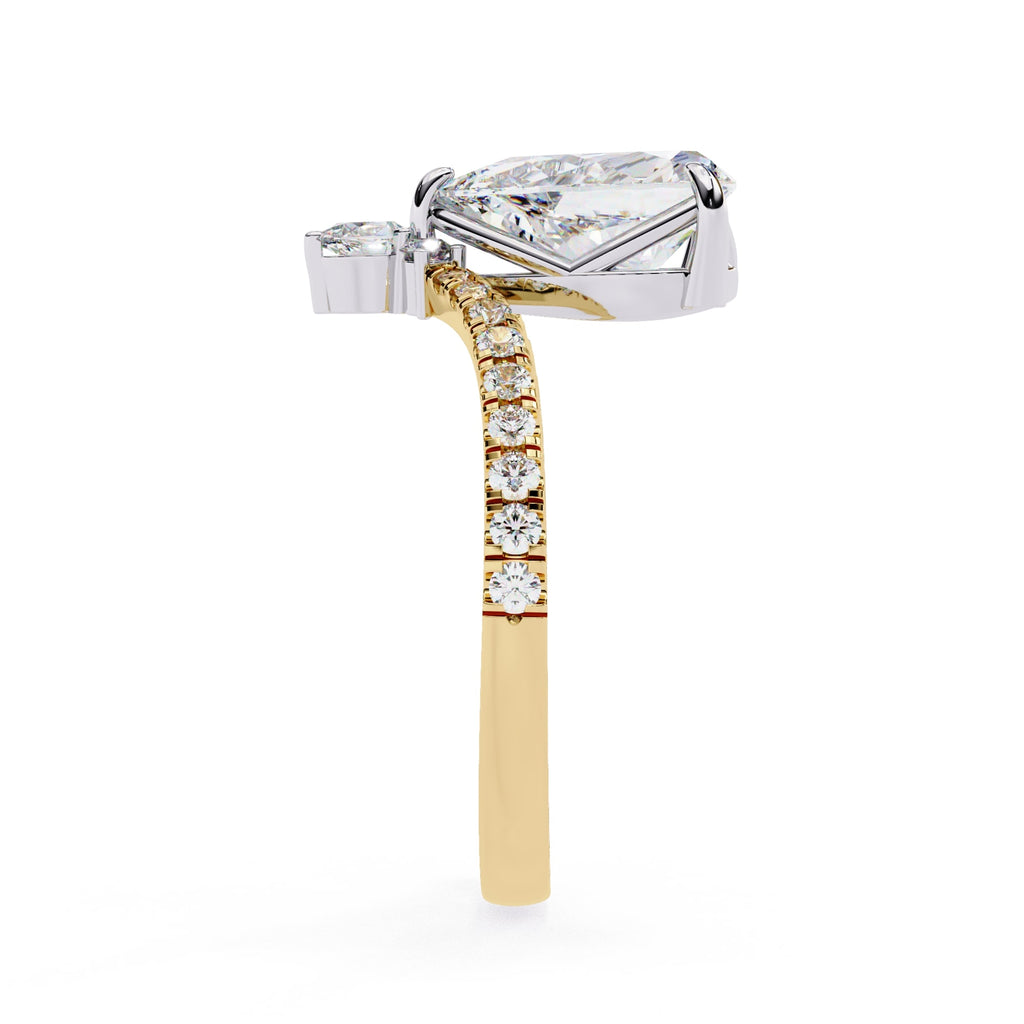 Diamond ring with a pear-shaped center stone and smaller diamonds on a gold band against a white background