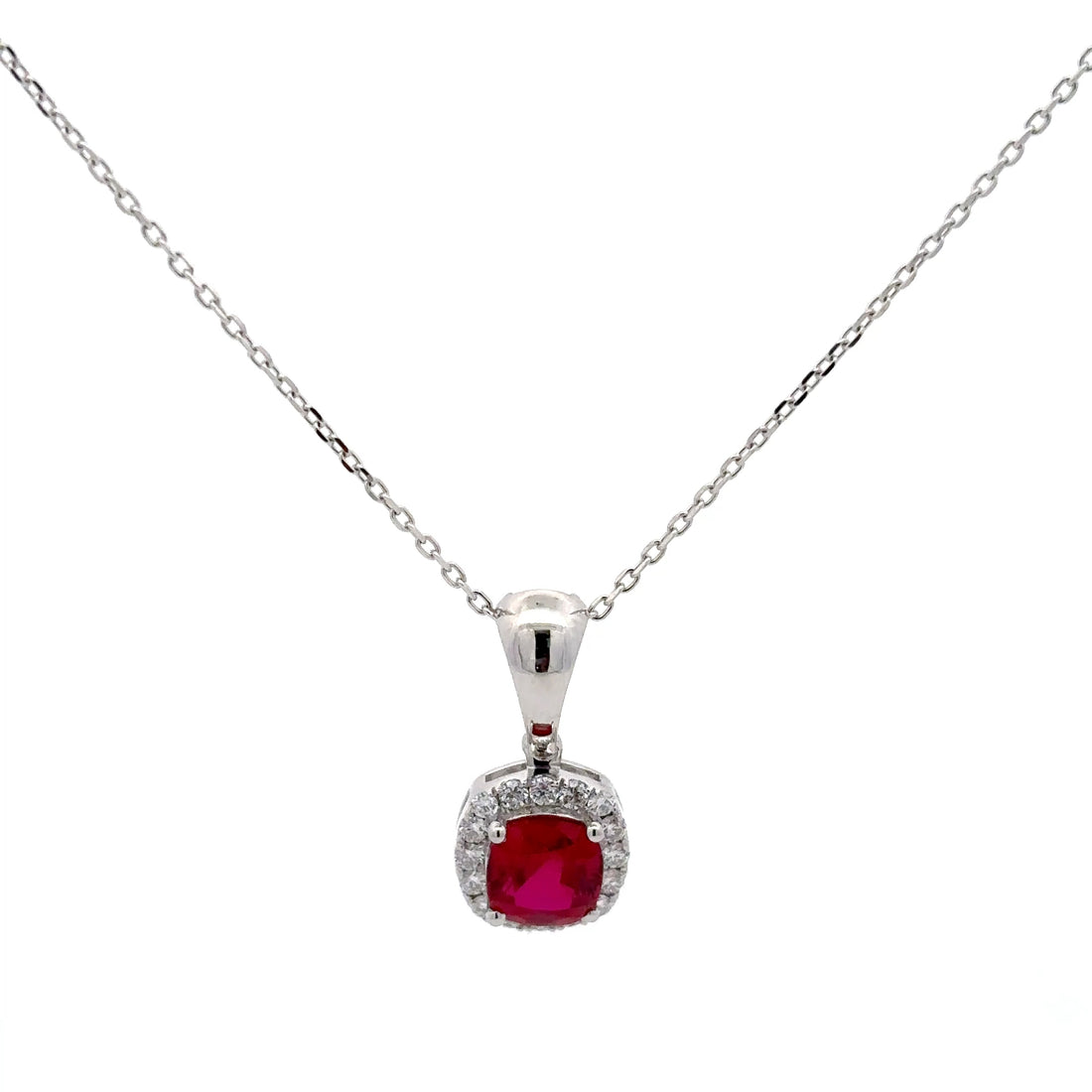 Silver necklace with a red gemstone pendant on a white background