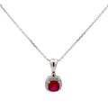 Silver necklace with a red gemstone pendant on a white background