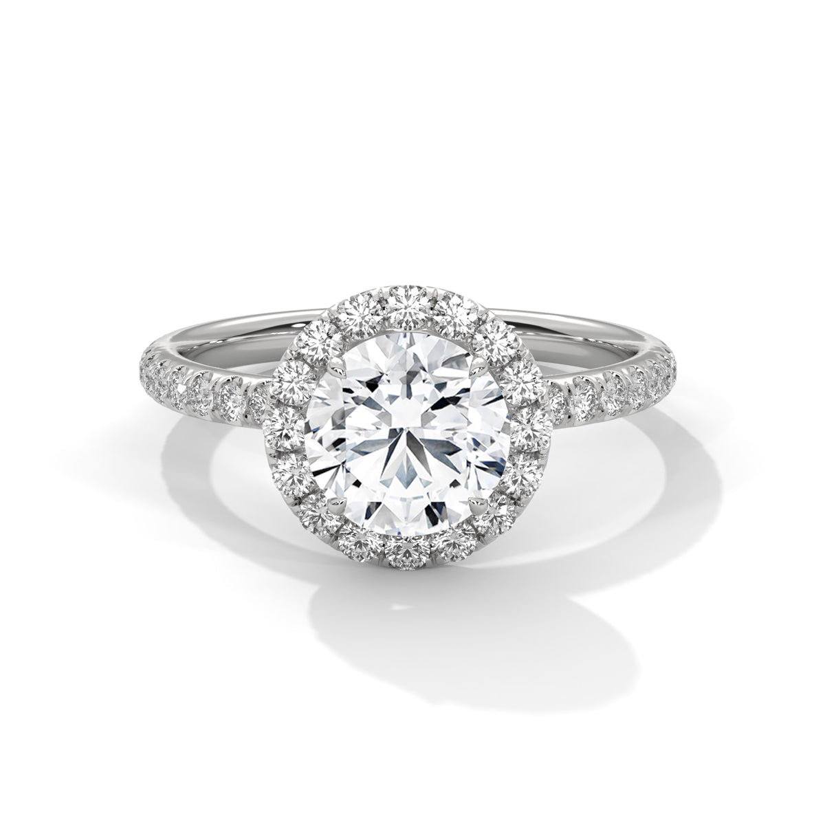 Round cut diamond halo engagement ring in white gold with a pavé diamond band, shown in a front product view.