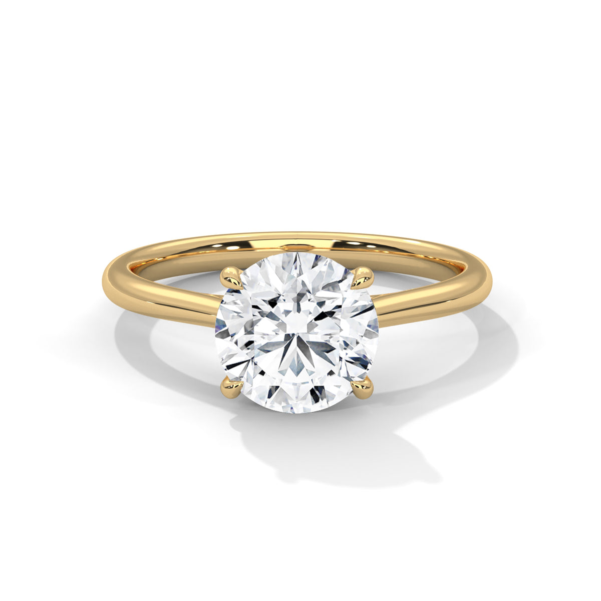 Round cut diamond solitaire engagement ring in yellow gold with a four-prong setting and plain band, shown in a front product view.