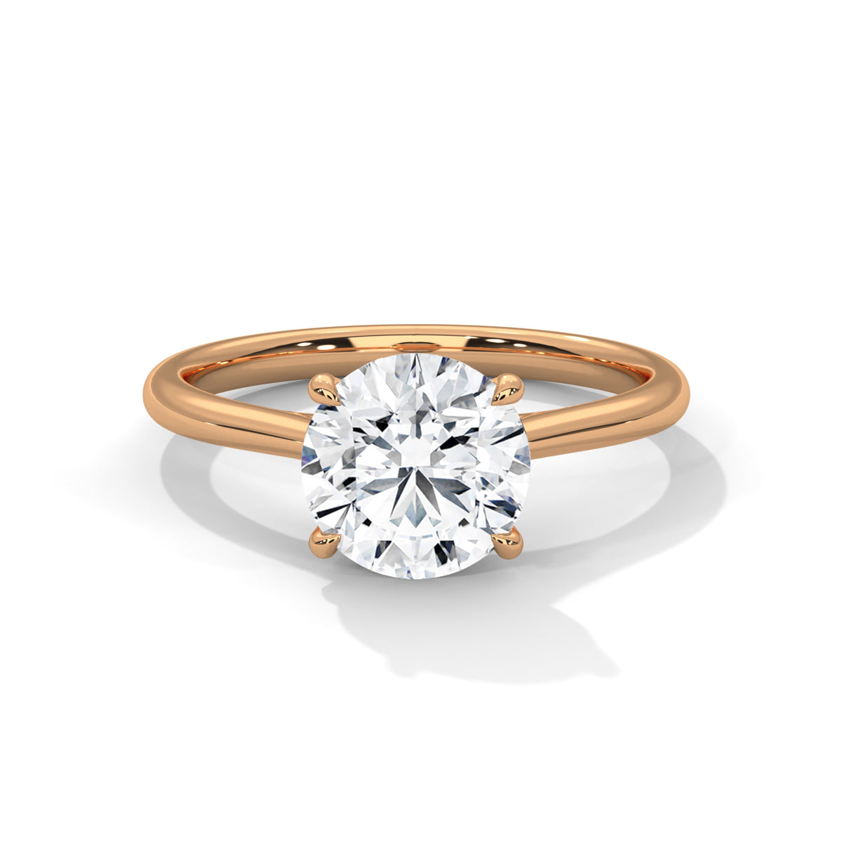 Round cut diamond solitaire engagement ring in rose gold with a four-prong setting and plain band, shown in a front product view.
