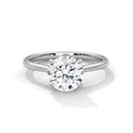 Round cut diamond solitaire engagement ring in white gold with a four-prong setting and plain band, shown in a front product view.