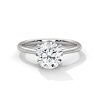 Round cut diamond solitaire engagement ring in white gold with a four-prong setting and plain band, shown in a front product view.