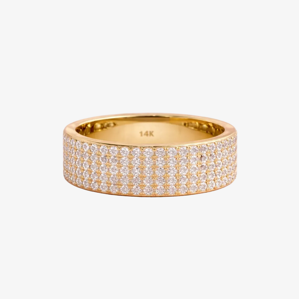 Gold ring with diamonds on a pink background