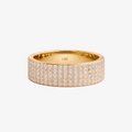 Gold ring with diamonds on a pink background