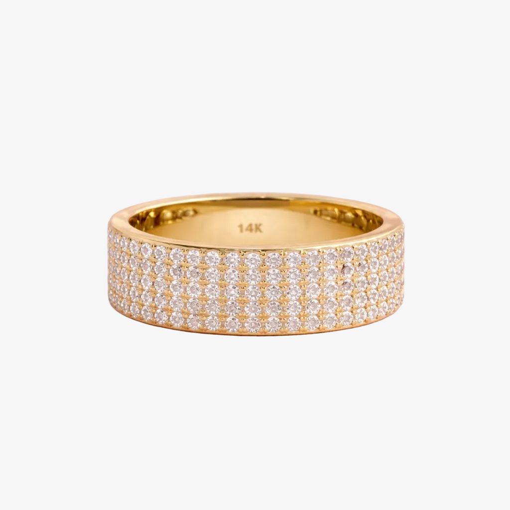 Gold ring with diamonds on a pink background