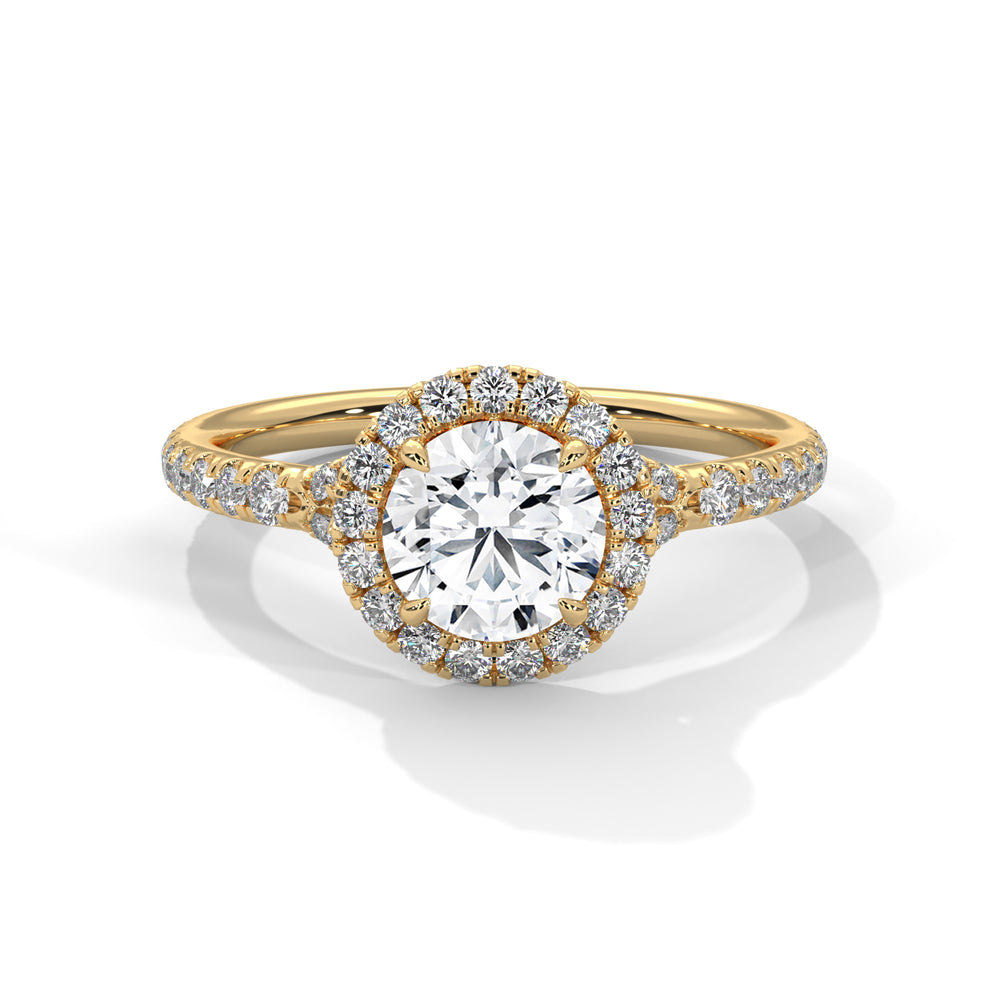 Round cut diamond halo engagement ring in yellow gold with a pavé diamond band, shown in a front product view.