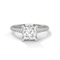 Princess cut diamond engagement ring in white gold with a pavé diamond band and four-prong setting, shown in a front product view.