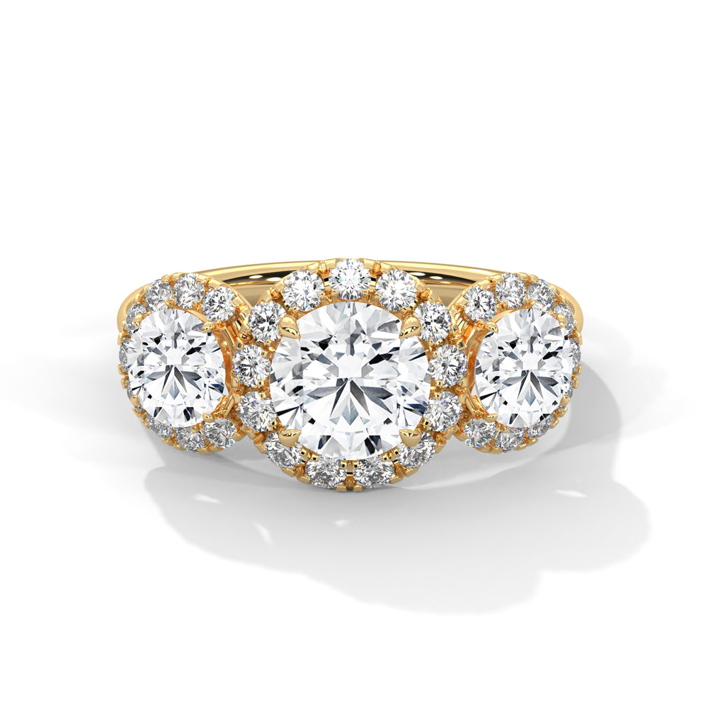 Three-stone round cut diamond engagement ring in yellow gold with diamond halos around the center and side stones, shown in a front product view.