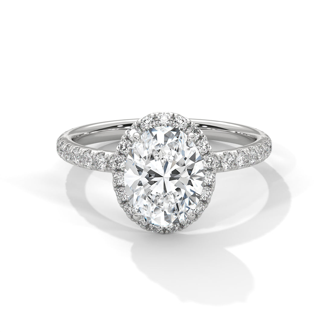 Oval cut diamond halo engagement ring in white gold with a pavé diamond band, shown in a front product view.