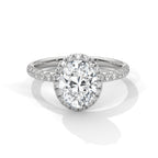 Oval cut diamond halo engagement ring in white gold with a pavé diamond band, shown in a front product view.