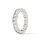 Silver ring with embedded diamonds on a white background