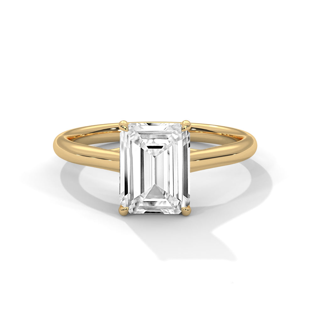 Emerald cut diamond solitaire engagement ring in yellow gold with a four-prong setting and plain band, shown in a front product view.