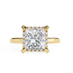 Gold ring with a large diamond on a white background