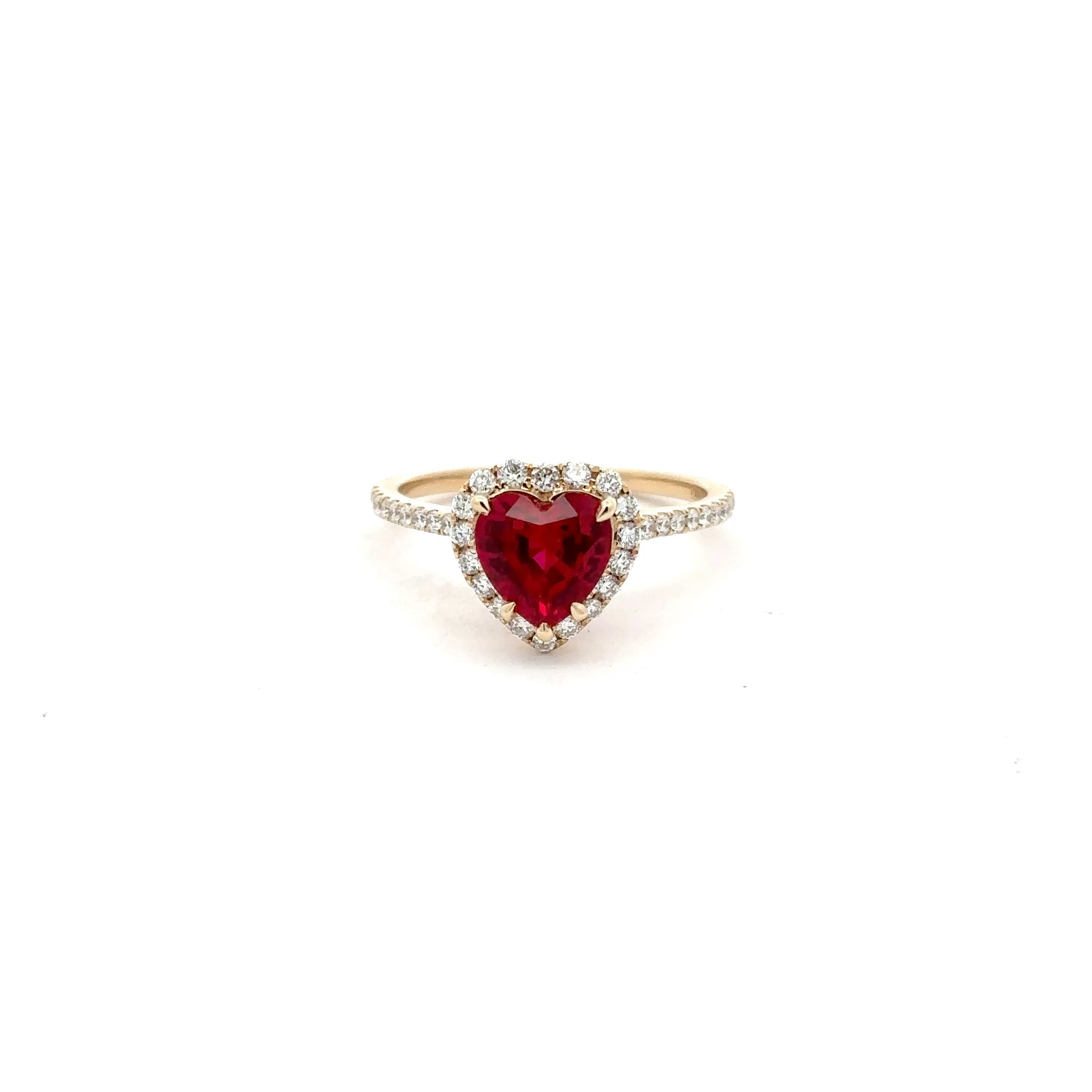 Ring with a heart-shaped red gemstone on a white background