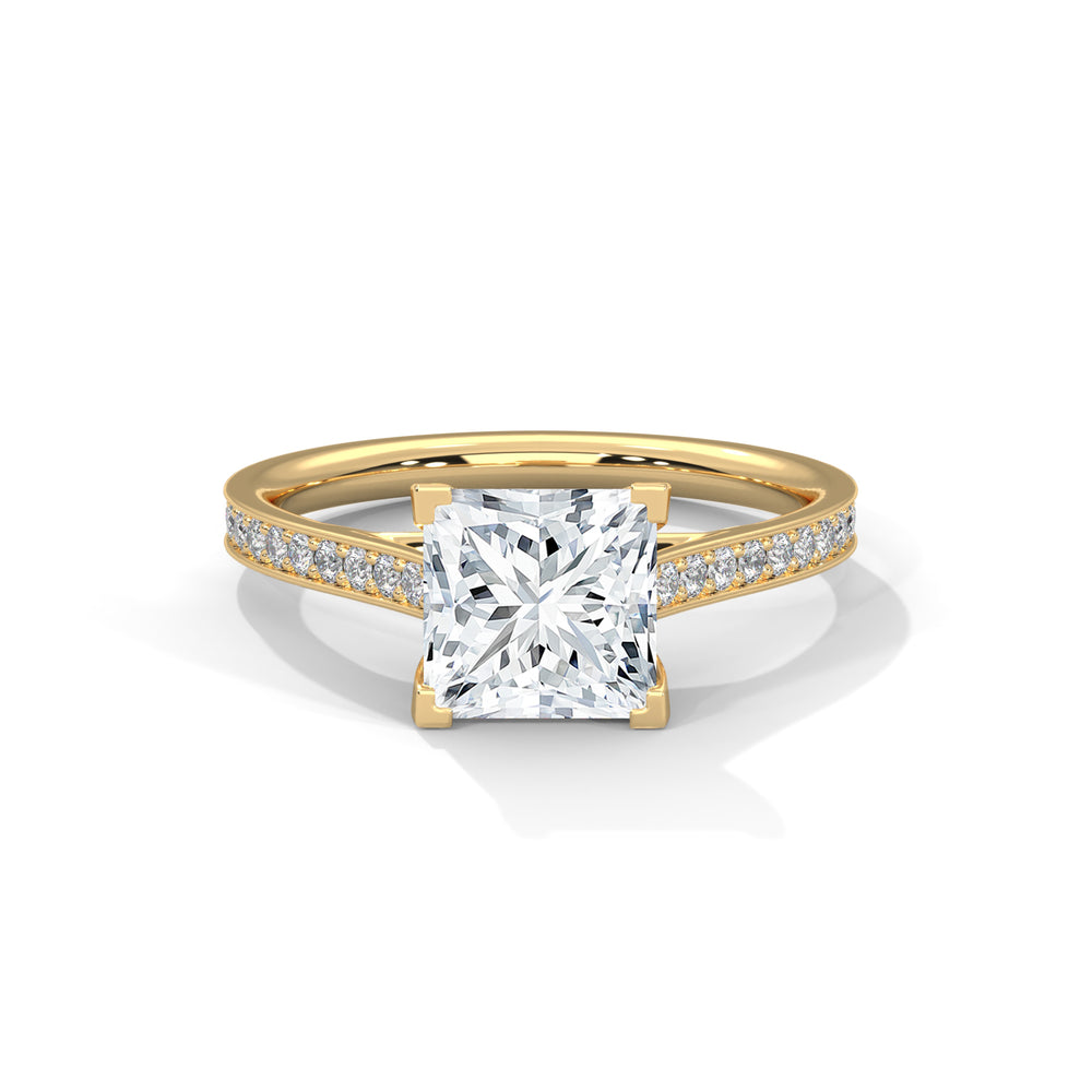 Gold ring with a large diamond and smaller diamonds on the band against a white background