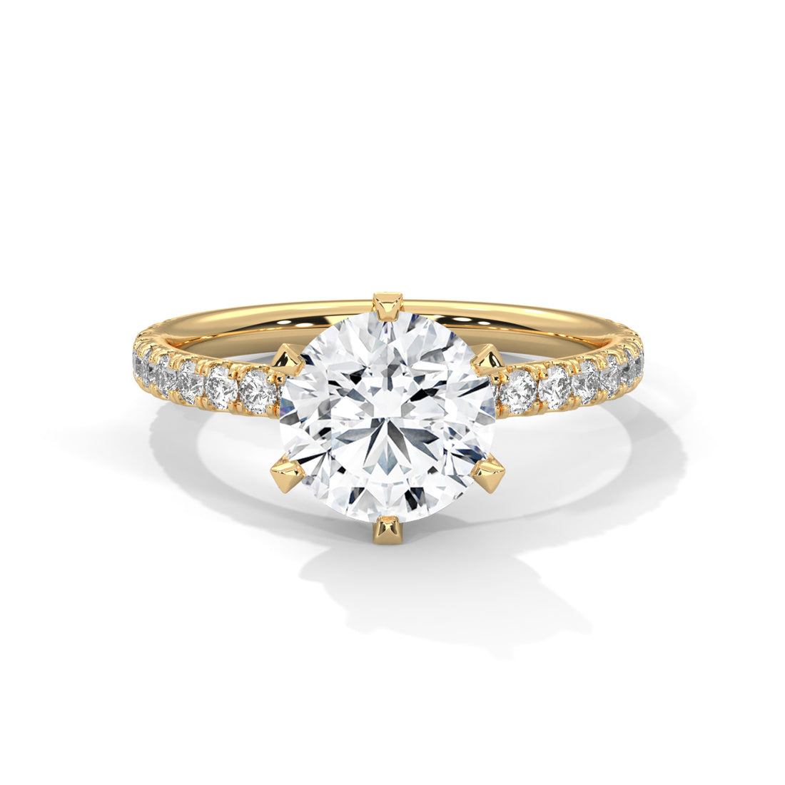 Gold ring with a large diamond and smaller diamonds on the band against a white background
