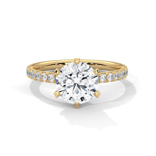 Gold ring with a large diamond and smaller diamonds on the band against a white background