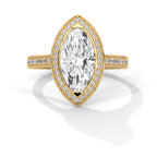 Gold ring with a large diamond and smaller diamonds on the band against a white background