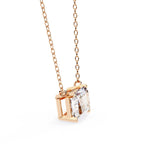 Rose gold necklace with a diamond pendant on a white background