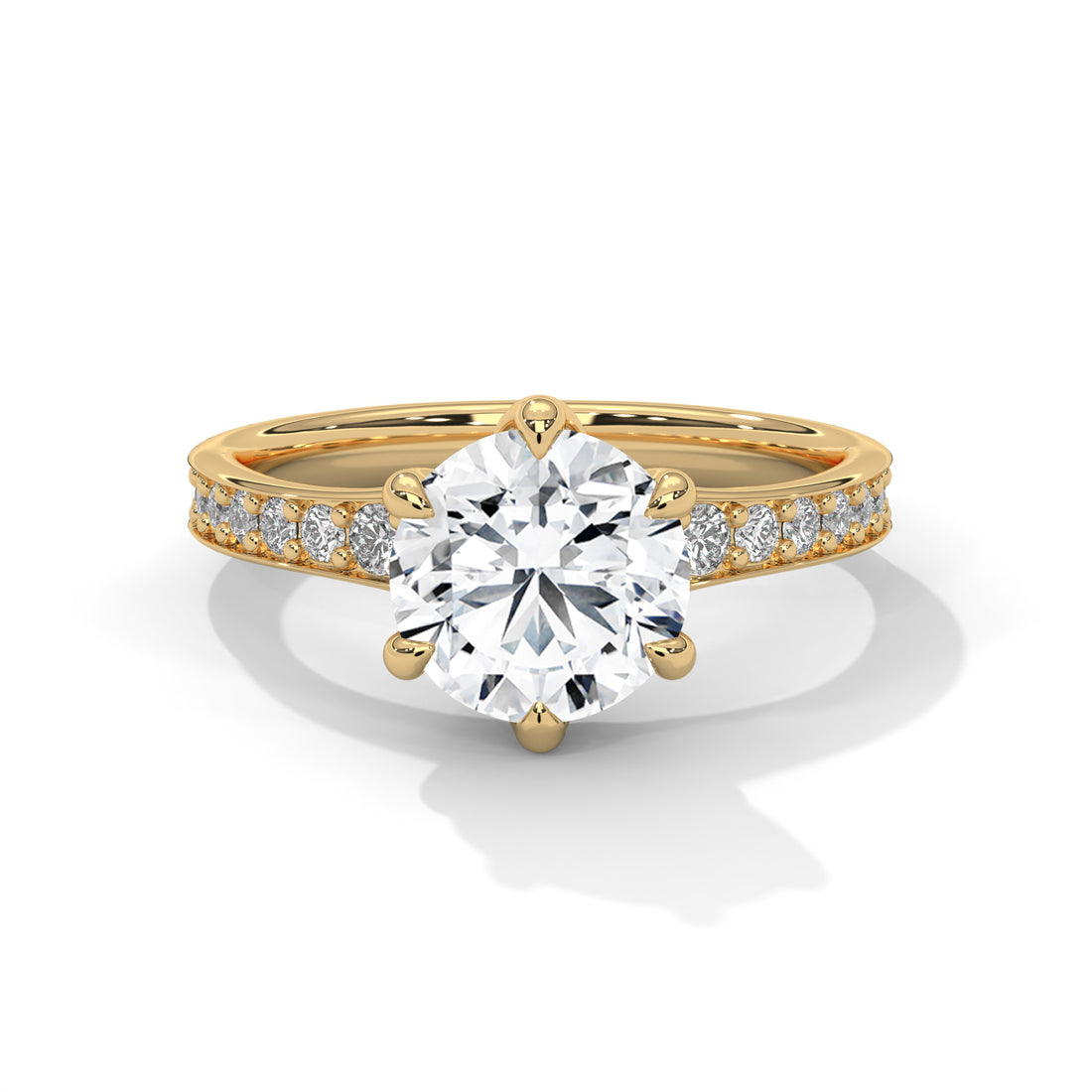 Gold ring with a large diamond and smaller diamonds on the band against a white background
