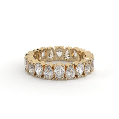 Gold ring with pear-shaped diamonds on a white background