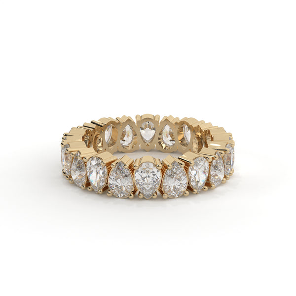 Gold ring with pear-shaped diamonds on a white background