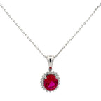 Silver necklace with a red gemstone pendant on a white background