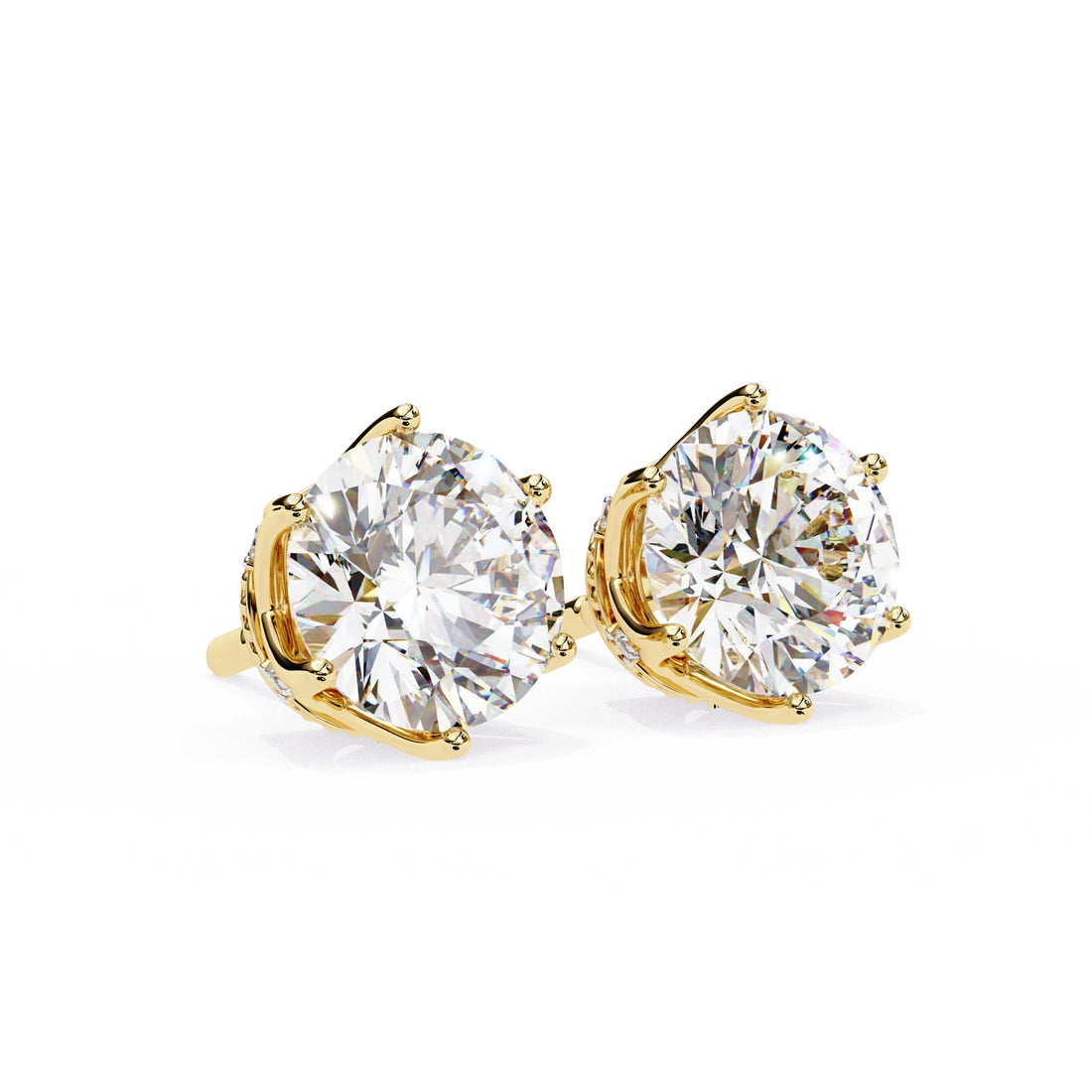 Gold earrings with large clear diamonds on a white background
