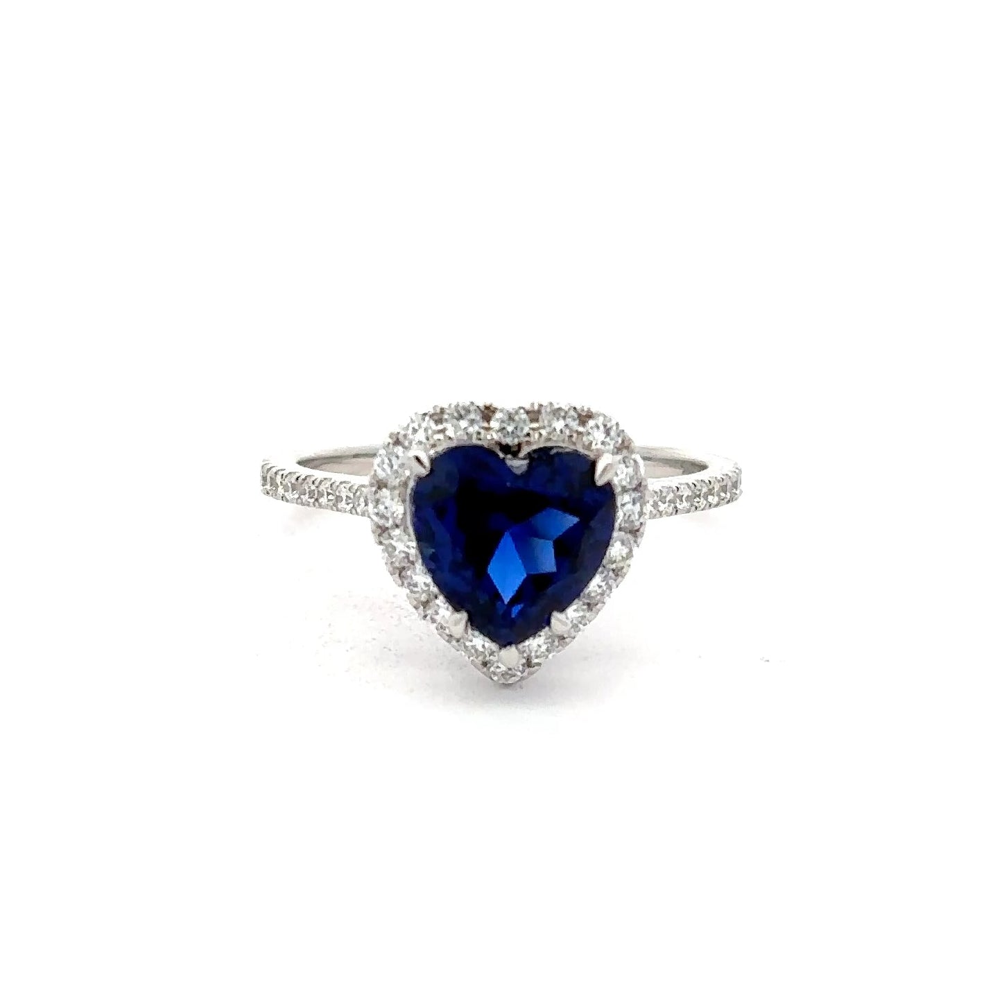 Heart-shaped blue gemstone ring with diamond accents in a white gold.