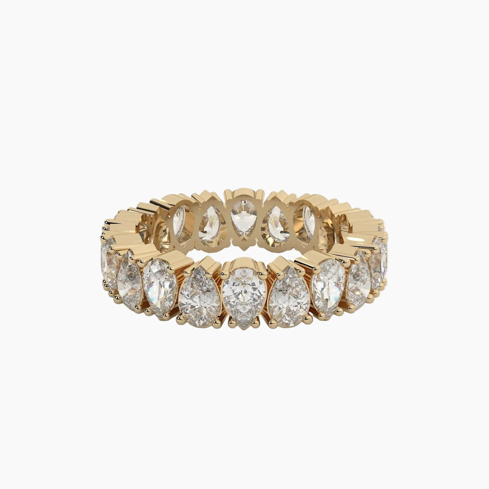 Gold ring with pear-shaped diamonds on a white background