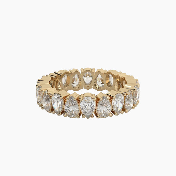 Gold ring with pear-shaped diamonds on a white background