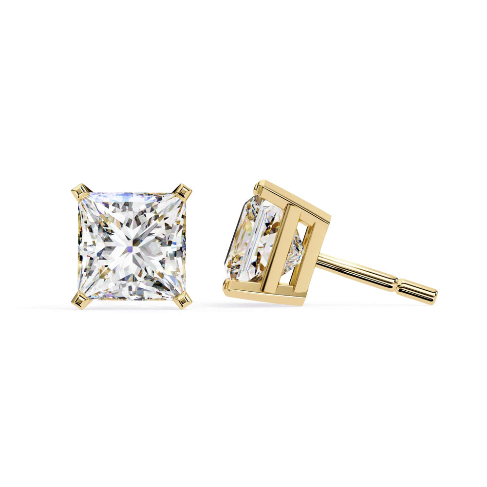 Gold stud earrings with clear gemstones on a white background