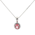 Pink gemstone pendant on a silver chain against a white background
