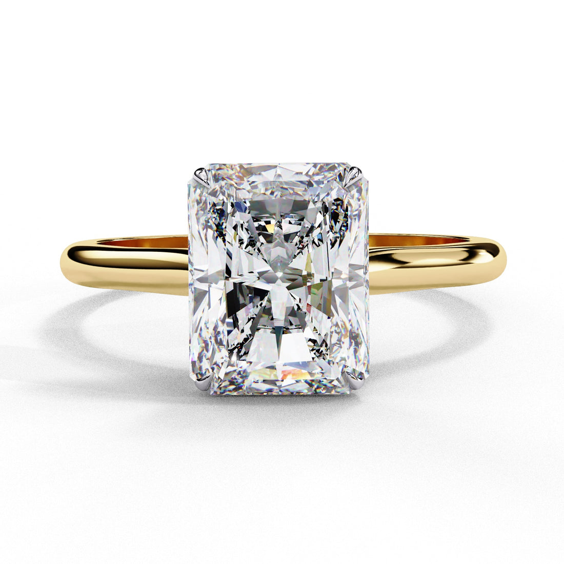 Gold ring with a large rectangular diamond on a white background