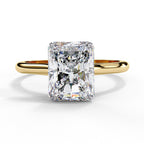 Gold ring with a large rectangular diamond on a white background