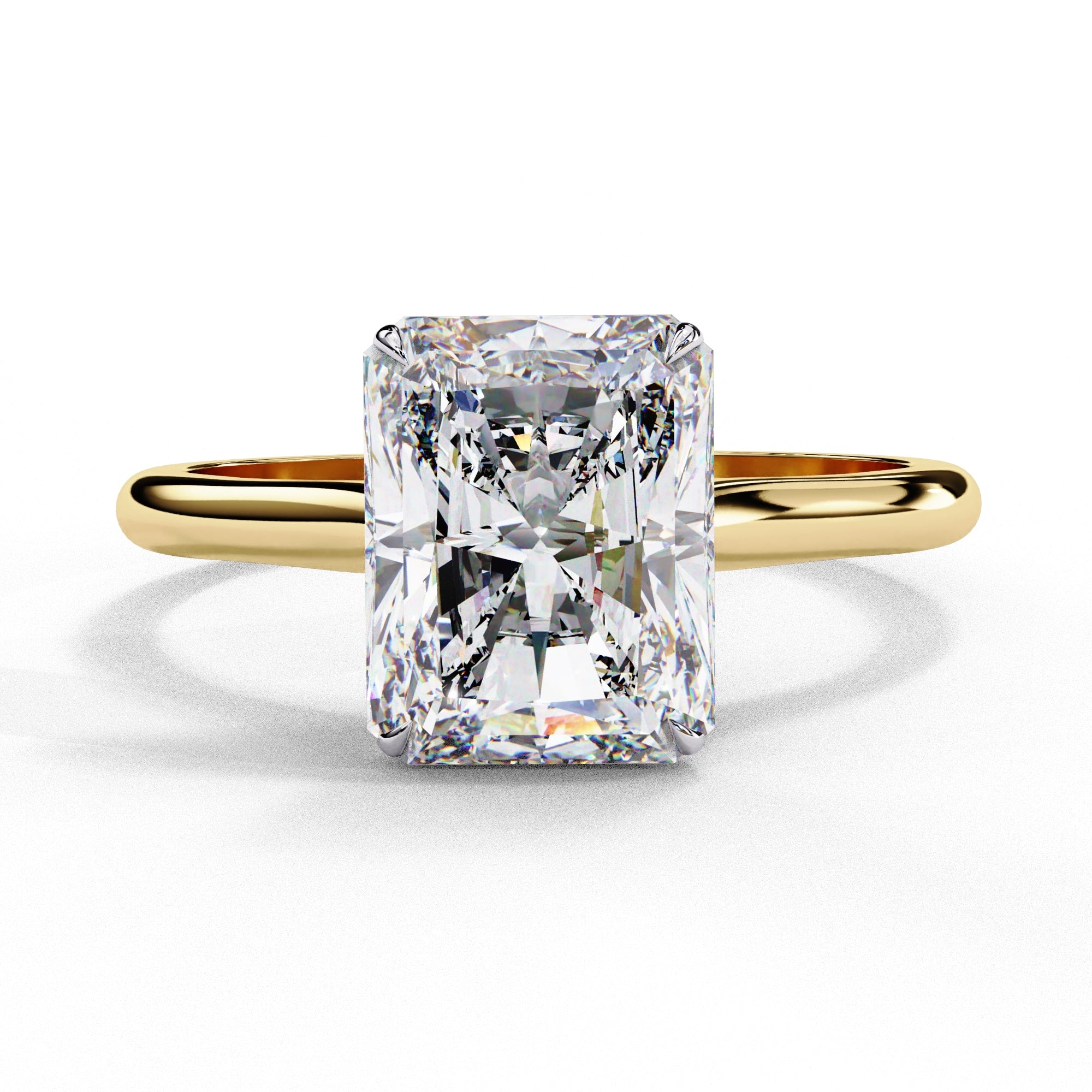 Gold ring with a large rectangular diamond on a white background