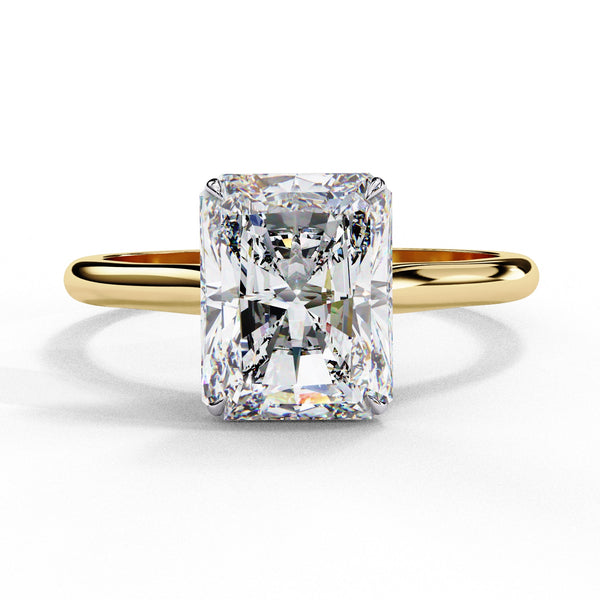 Gold ring with a large rectangular diamond on a white background