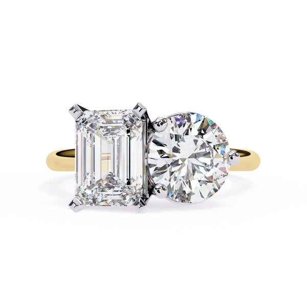 Diamond ring with emerald-cut and round-cut diamonds on a white background