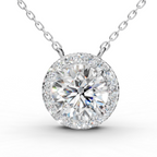 A round halo diamond pendant necklace on a delicate silver chain, set against a clean white background.