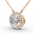 A round rose gold pendant necklace featuring a large round-cut clear center stone surrounded by a halo of smaller clear stones, suspended from a delicate rose gold chain against a white background.