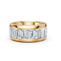 Gold ring with emerald-cut diamonds on a white background