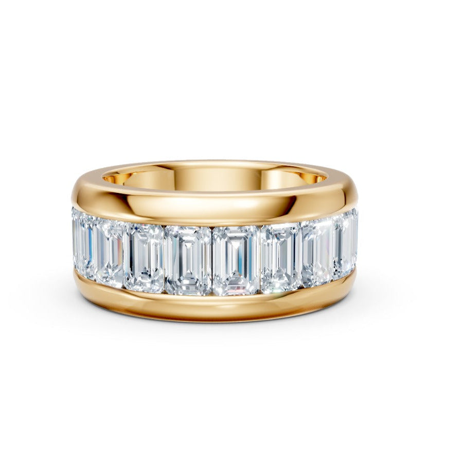 Gold ring with emerald-cut diamonds on a white background