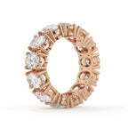 Rose gold ring with diamonds on a white background