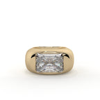 Gold ring with a large diamond on a white background