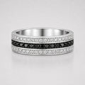 Channel set round black and white diamond men's wedding band featuring a center row of black diamonds framed by white diamond rows in a polished white gold band.
