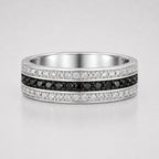 Channel set round black and white diamond men's wedding band featuring a center row of black diamonds framed by white diamond rows in a polished white gold band.
