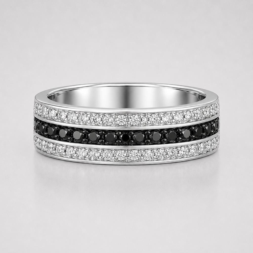 Silver ring with black and white gemstones on a light gray background